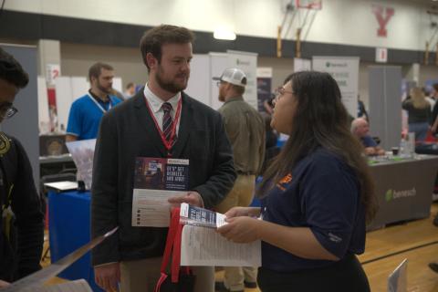 A student speaks with an employer rep at the Fall 2022 STEM Expo